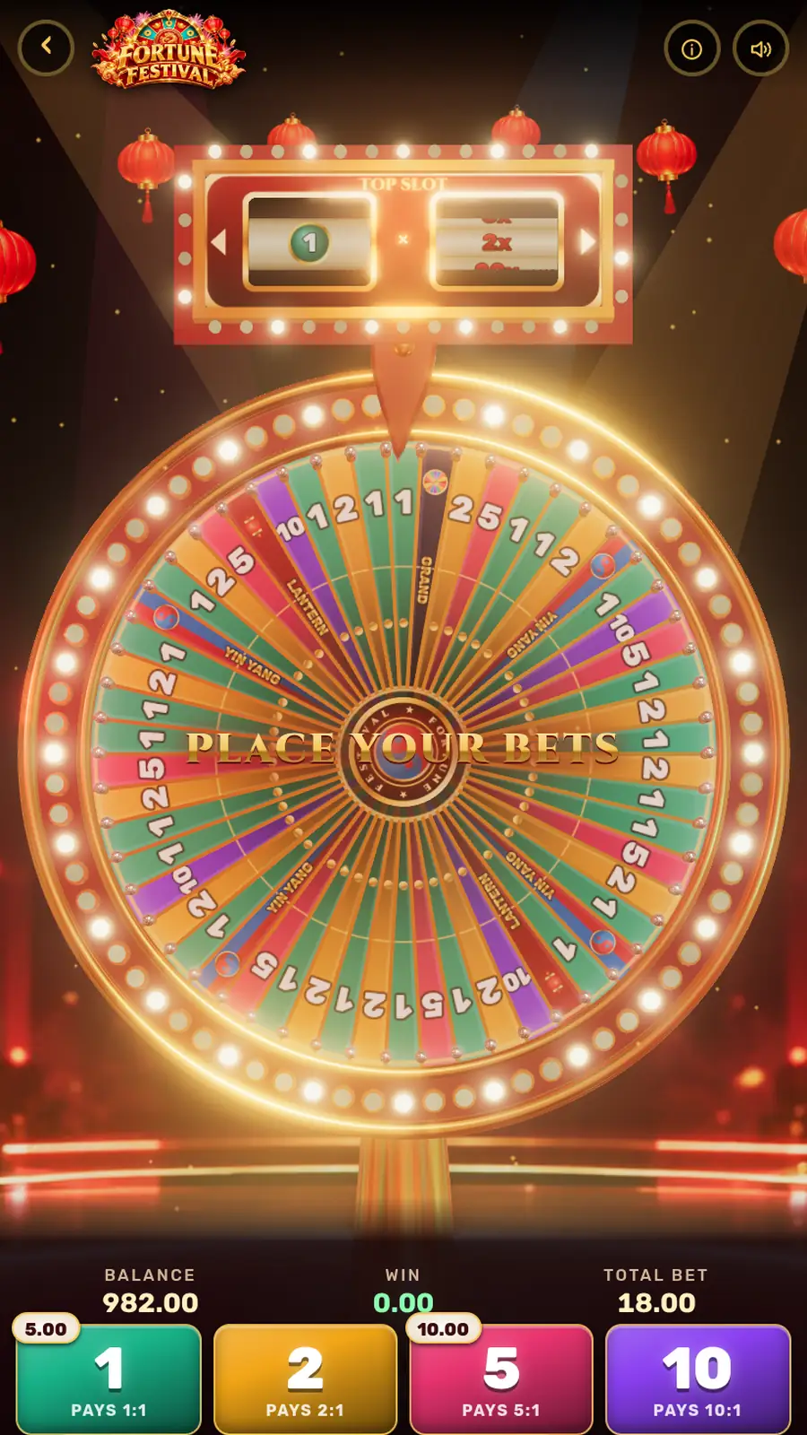 Fortune Festival: a giant glowing money wheel with a top slot multiplier, under red lanterns in a game show studio